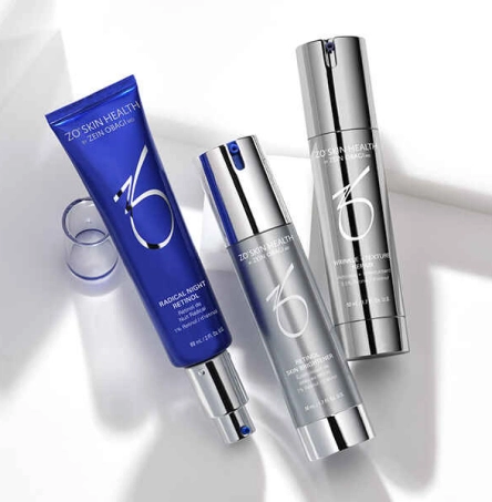 ZO Skin Health skincare products including blue tube cleanser and silver serum bottles on white background