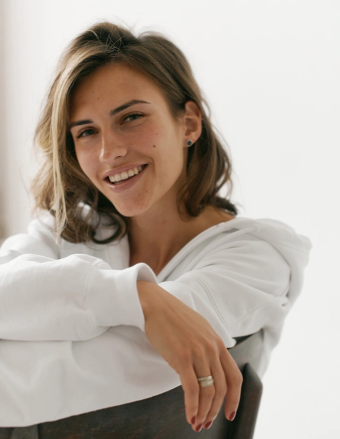 Smiling woman with shoulder-length brown hair wearing white shirt in professional portrait - ThermiSmooth in Alpharetta, GA